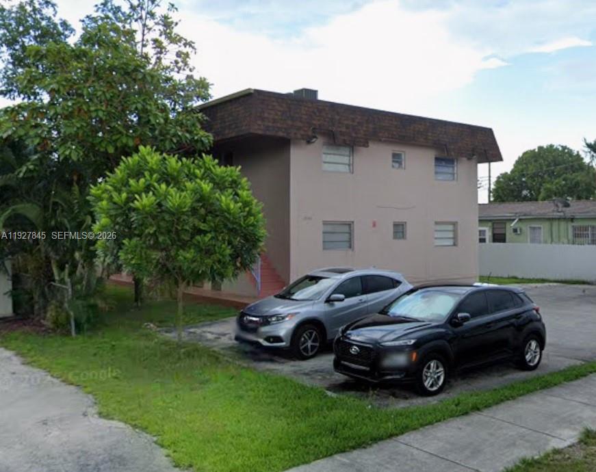 2155 Southwest 72nd Avenue Miami, FL 33155 - Photo 11 of 11 a car parked in front of a house with a garden