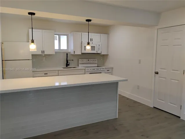 a bathroom with a sink a mirror and a shower