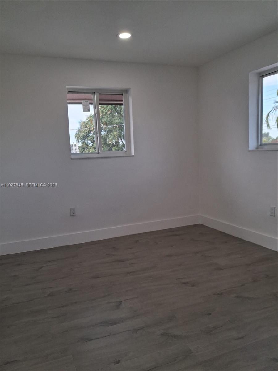 2155 Southwest 72nd Avenue Miami, FL 33155 - Photo 5 of 11 a view of an empty room with wooden floor and a window