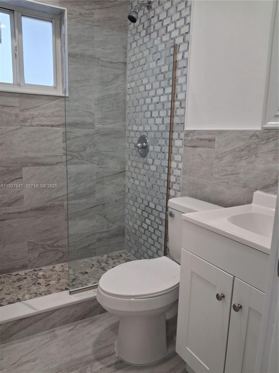 2155 Southwest 72nd Avenue Miami, FL 33155 - Photo 7 of 10 a white toilet sitting next to a shower