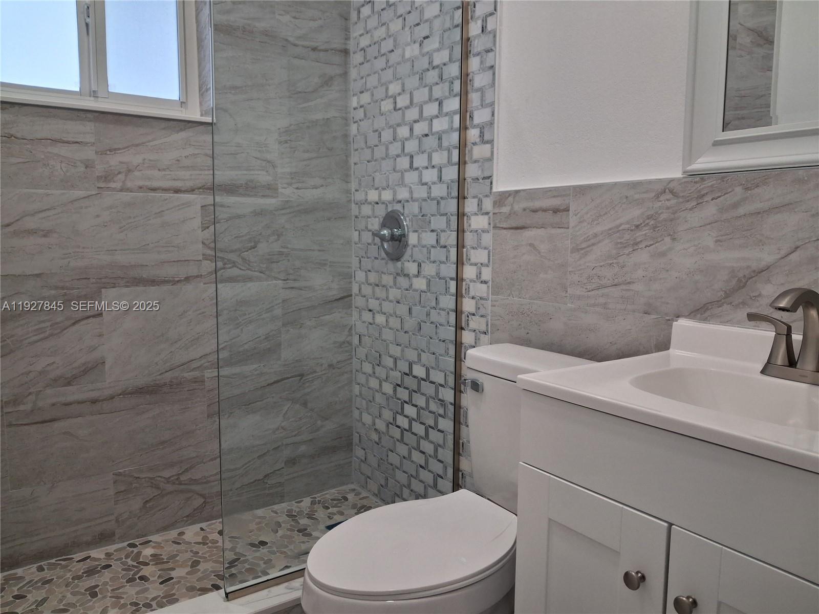 2155 Southwest 72nd Avenue Miami, FL 33155 - Photo 8 of 10 a bathroom with a sink a toilet and shower