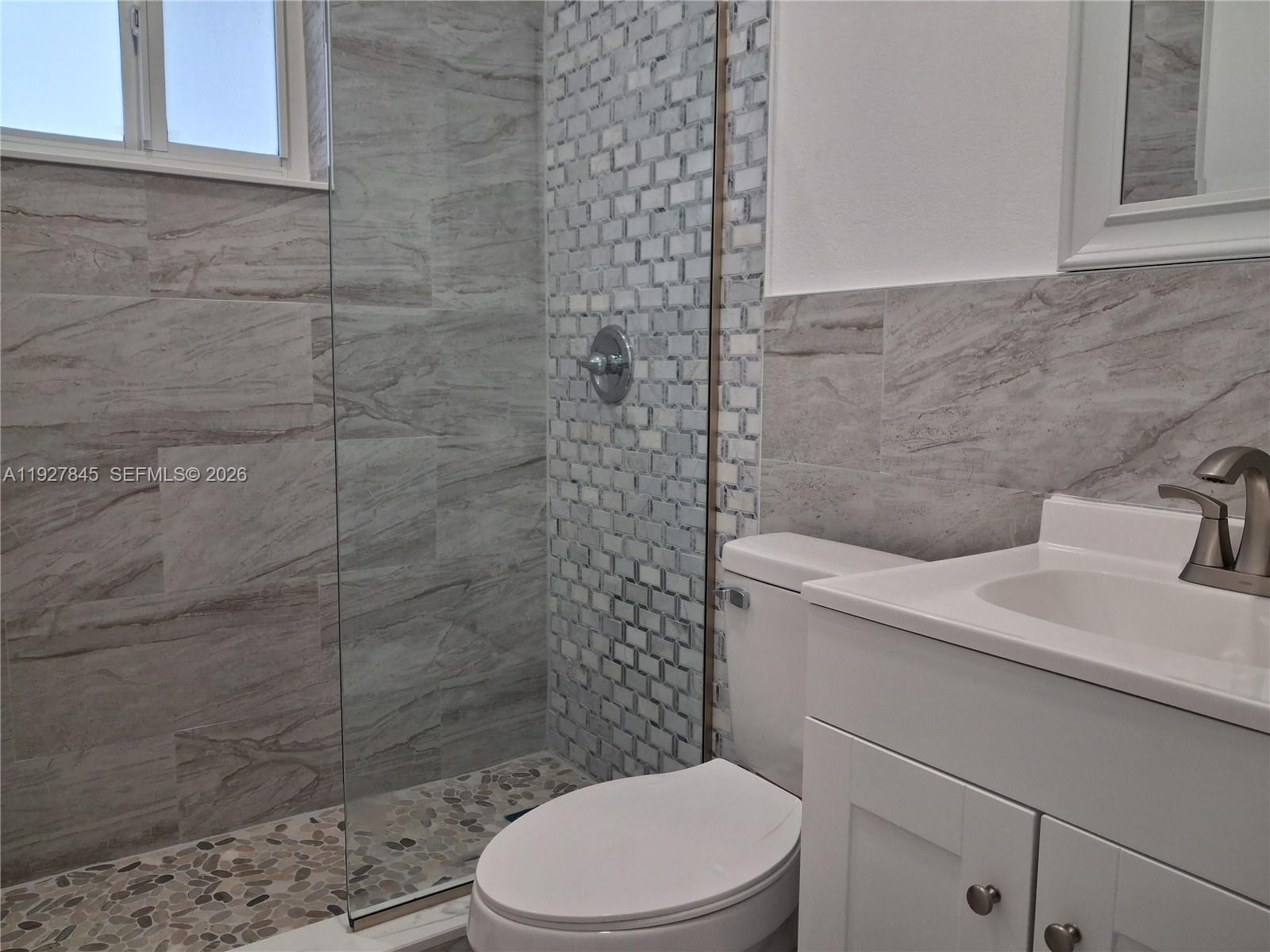 2155 Southwest 72nd Avenue Miami, FL 33155 - Photo 8 of 11 a bathroom with a sink a toilet and shower