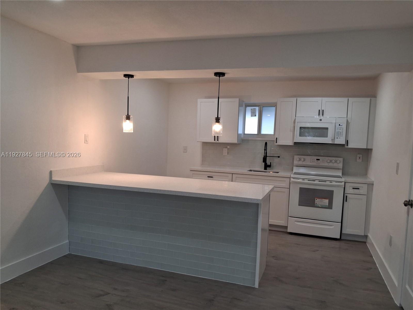 2155 Southwest 72nd Avenue Miami, FL 33155 - Photo 9 of 11 a kitchen with white cabinets and white appliances