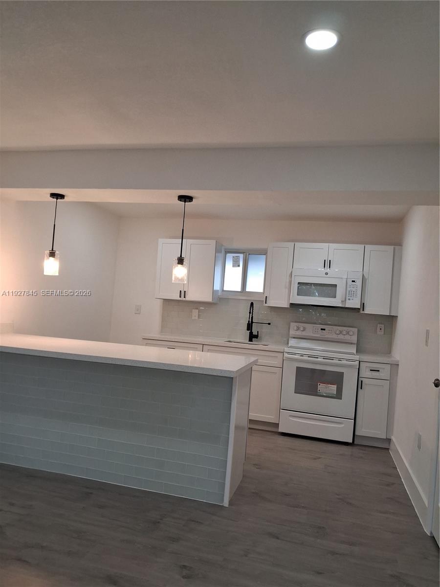 2155 Southwest 72nd Avenue Miami, FL 33155 - Photo 10 of 11 a kitchen with cabinets appliances and a counter space