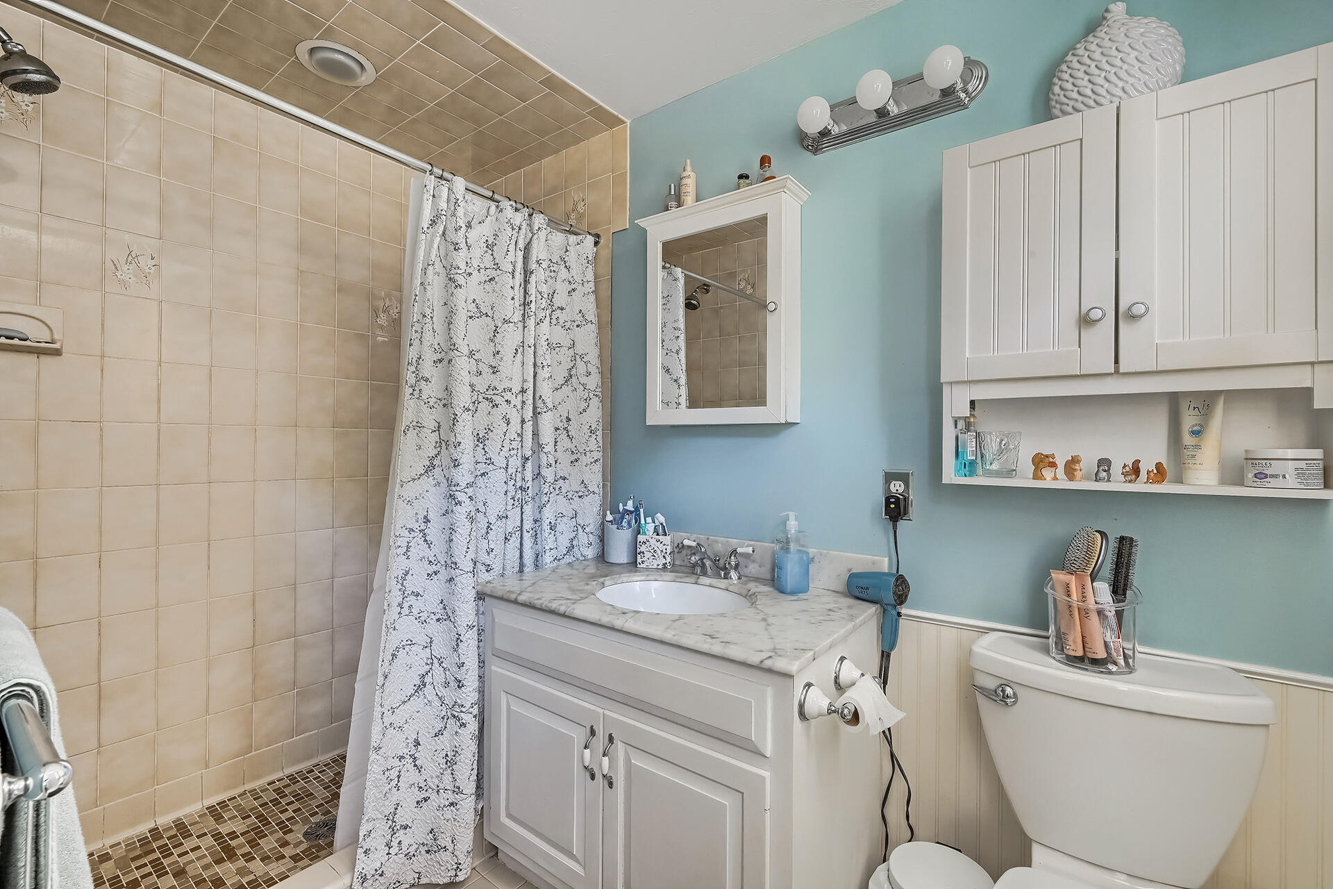 61 Merideth Way Centerville, MA 02632 - Photo 17 of 32 a bathroom with a granite countertop sink a toilet a shower and a mirror