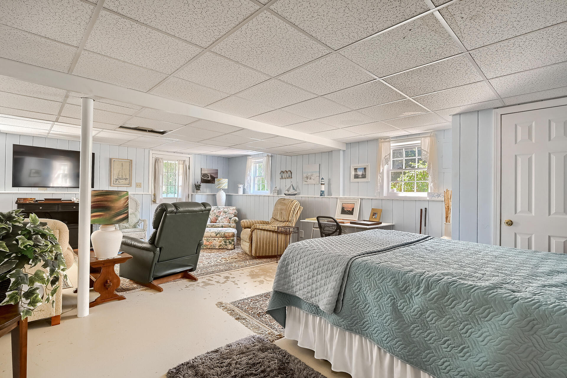 61 Merideth Way Centerville, MA 02632 - Photo 24 of 32 a spacious bedroom with a bed a couch and dresser
