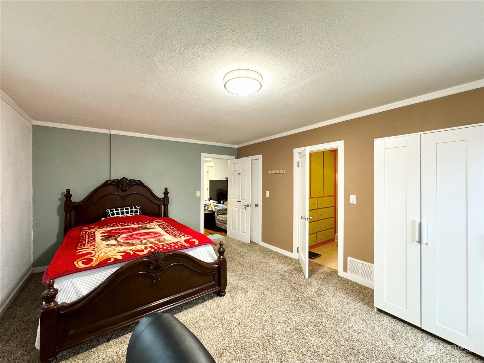 523 Main Avenue South Renton, WA 98057 - Photo 16 of 32 a bedroom with a bed and a walk in closet