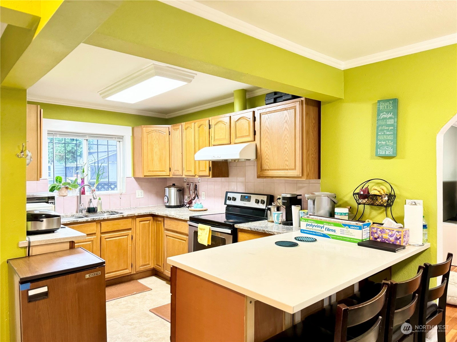 523 Main Avenue South Renton, WA 98057 - Photo 7 of 32 a kitchen with a sink a stove and chairs