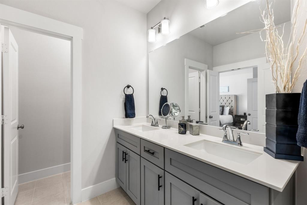 4502 Smokey Quartz Lane Arlington, TX 76005 - Photo 25 of 32 a bathroom with double sink and a mirror