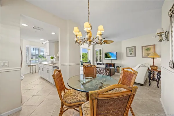 a large kitchen with kitchen island a sink a counter space and a large window