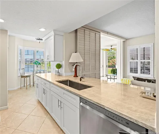 a dining room with furniture and large windows