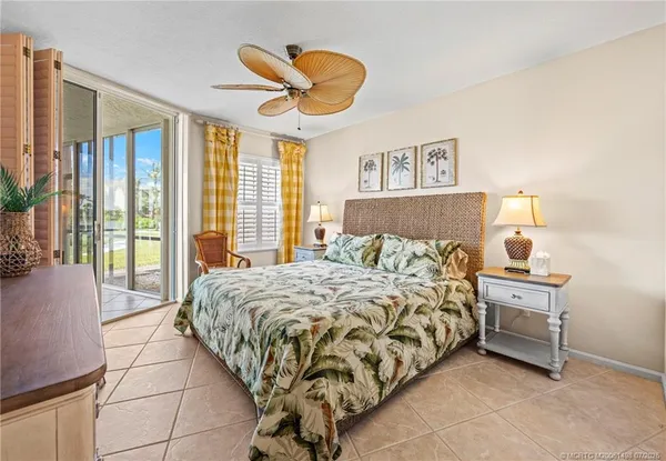 a bedroom with a bed couch and a window