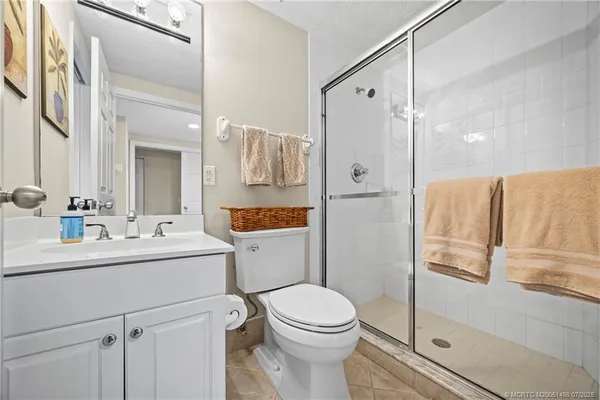 a view of a dining room with furniture a chandelier and wooden floor