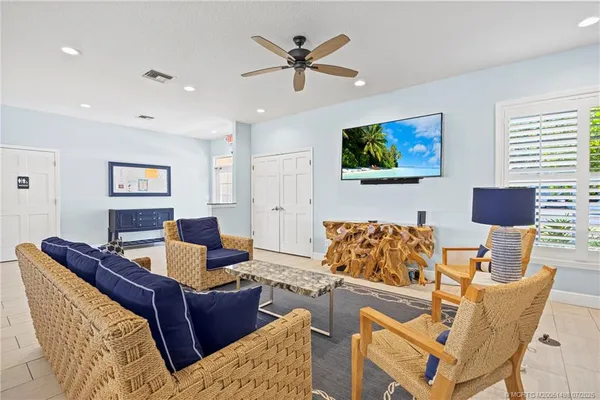 a kitchen with kitchen island a white cabinets and refrigerator