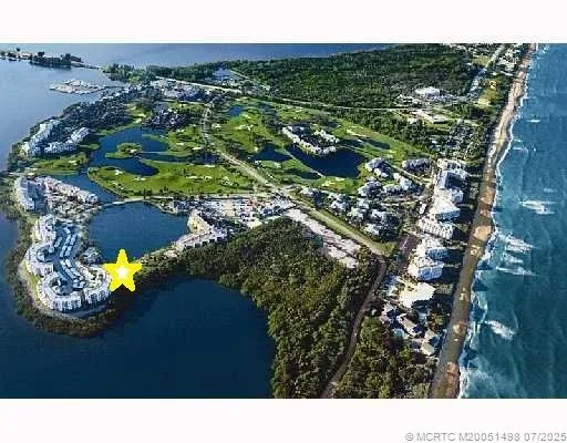 a view of a hallway with wooden floor and closet area