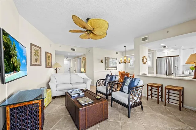 a living room with furniture a flat screen tv and a large window