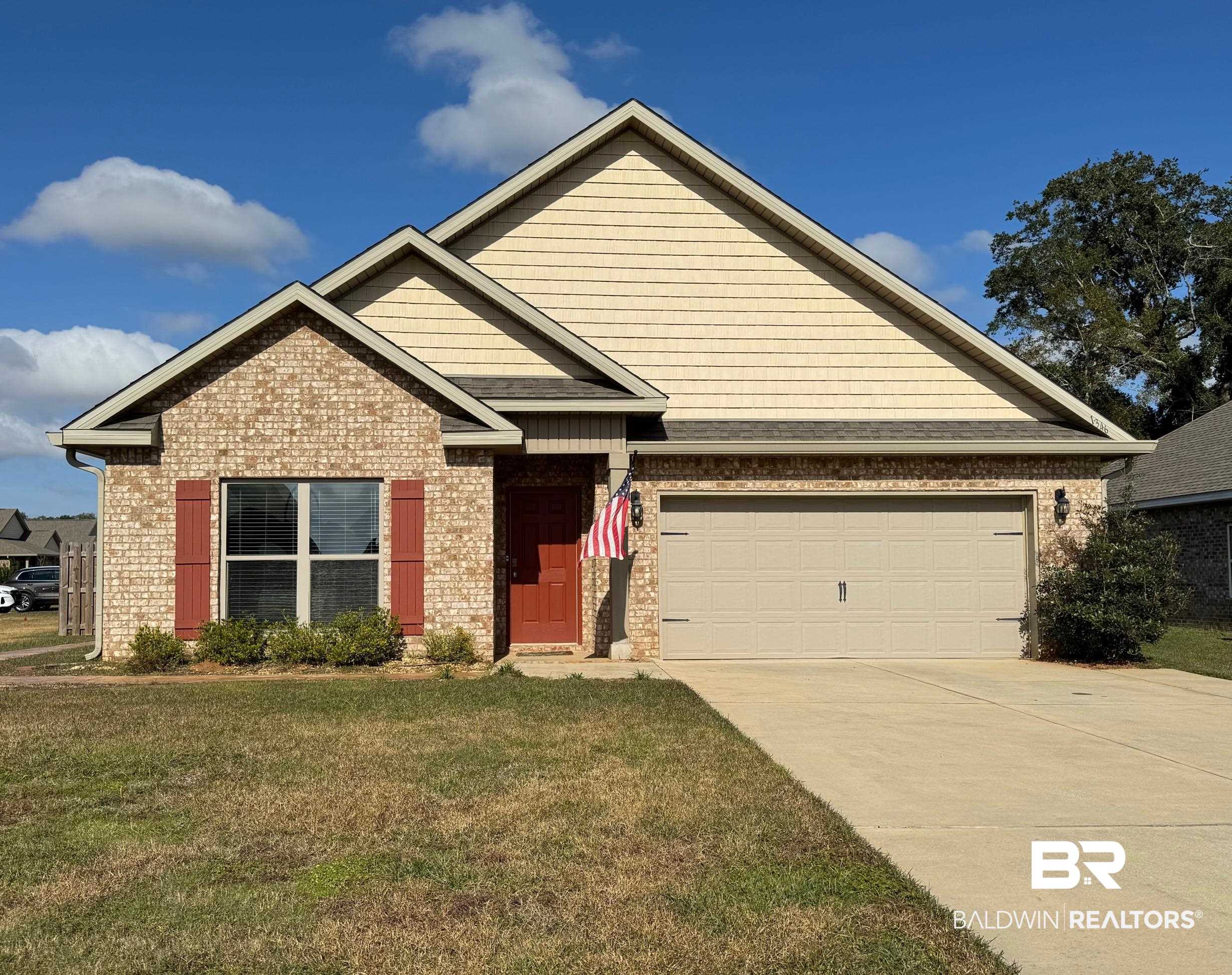 Craftsman-style house featuring a garage and a front yard