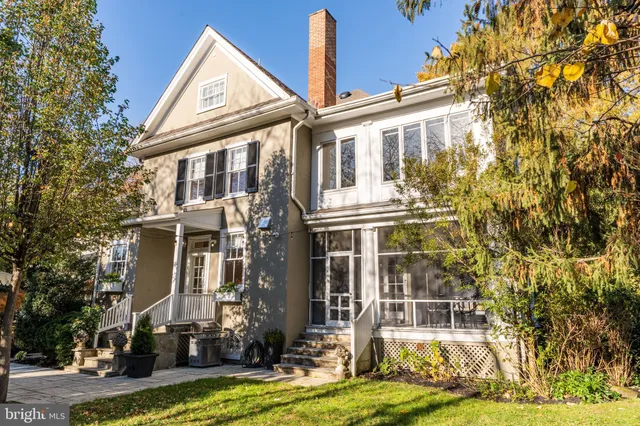 a bedroom with a bed and a lamp on dresser