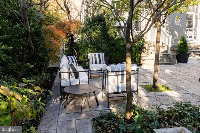 a living room with furniture and a baby crib
