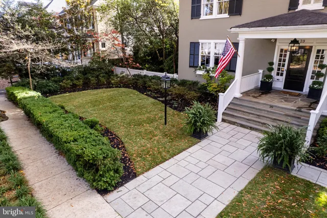 a view of a house with a yard and sitting area