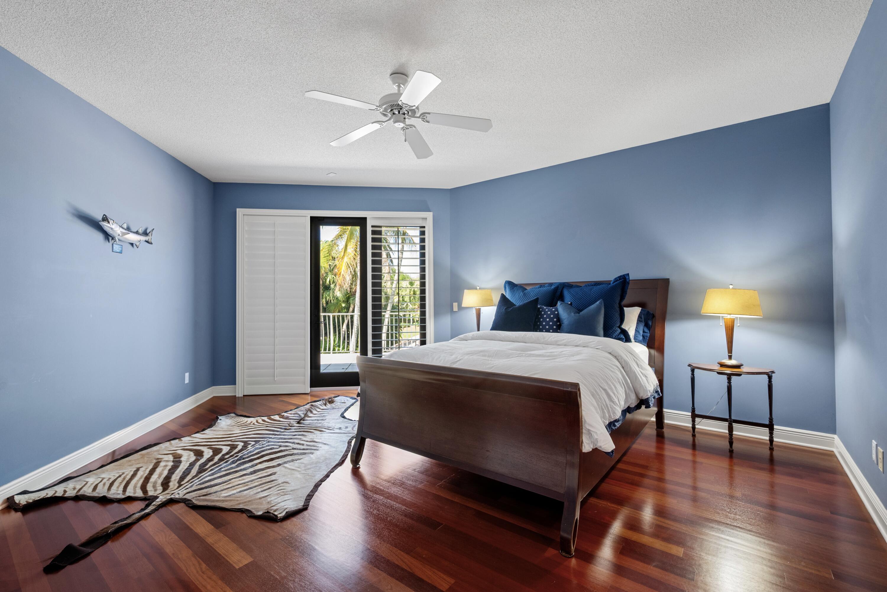 18800 Long Lake Drive Boca Raton, FL 33496 - Photo 38 of 60 a bedroom with a bed and wooden floor