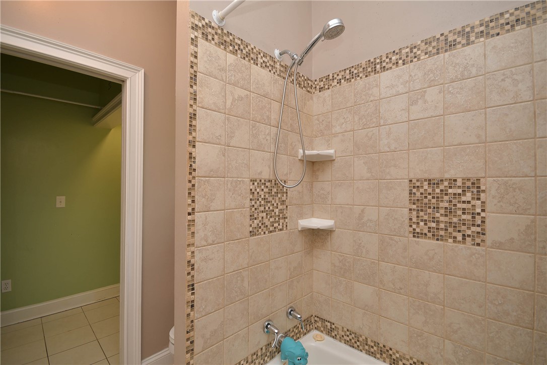 197 Deer Creek Road Easley, SC 29640 - Photo 29 of 50 A well-appointed shower features stylish tile work and practical shelving for comfort.