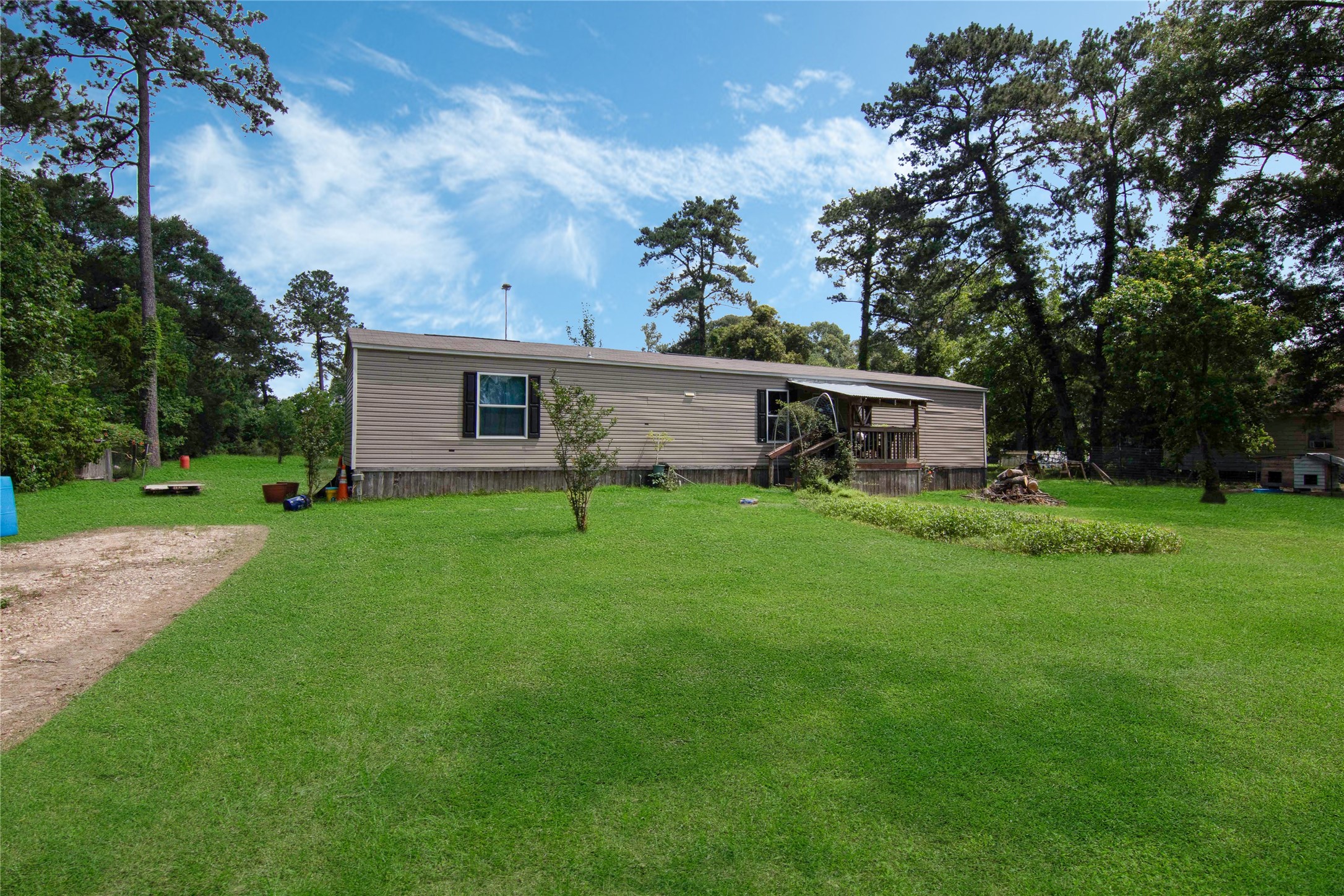 18093 Pickering Road Conroe, TX 77302 - Photo 2 of 29 a view of a house with a yard