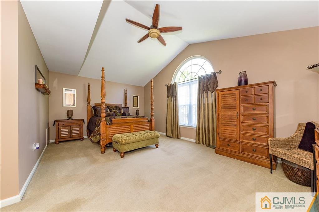 3 Rock Run Road East Windsor, NJ 08520 - Photo 16 of 25 a living room with furniture gym equipment and a chandelier