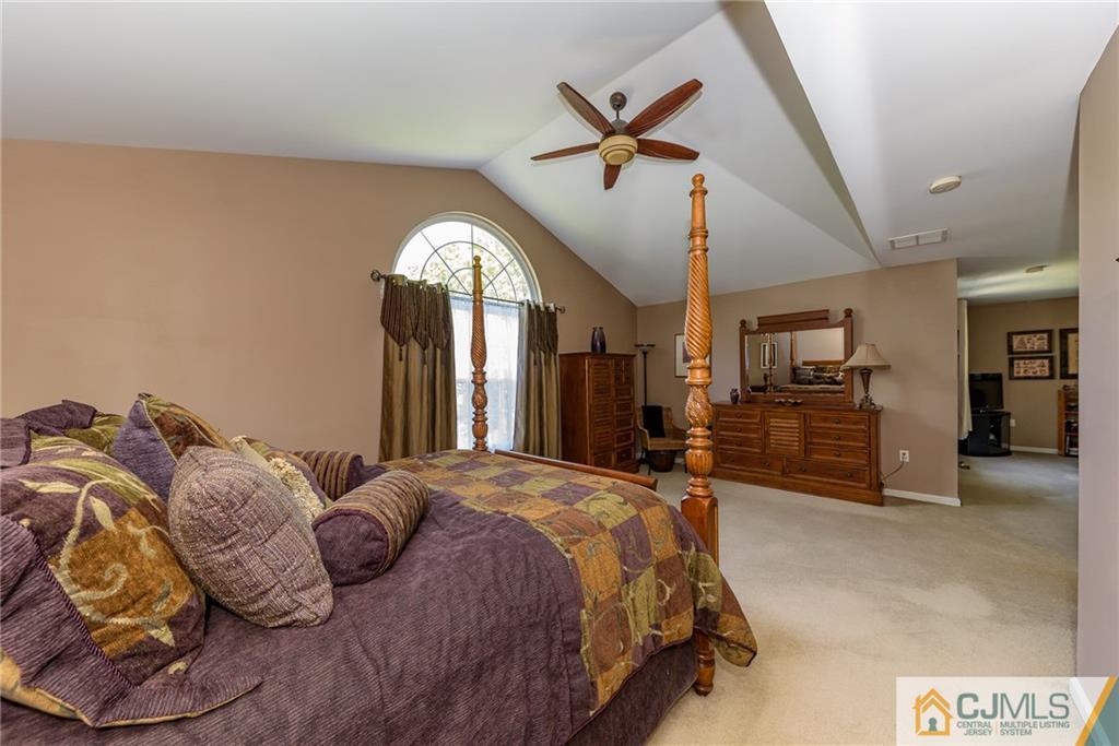 3 Rock Run Road East Windsor, NJ 08520 - Photo 17 of 25 a spacious bedroom with a bed a dresser and flat screen tv