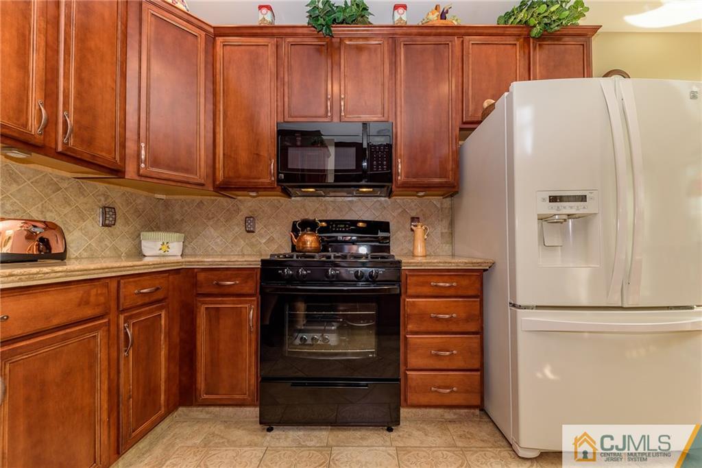 3 Rock Run Road East Windsor, NJ 08520 - Photo 7 of 25 a kitchen with stainless steel appliances a refrigerator stove and cabinets