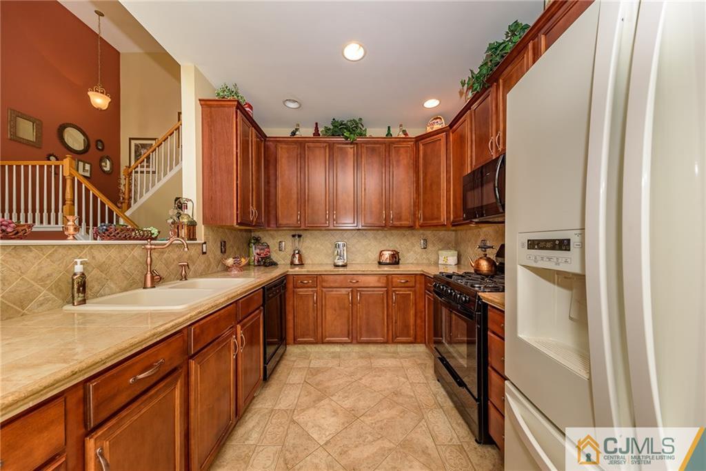 3 Rock Run Road East Windsor, NJ 08520 - Photo 8 of 25 a kitchen with a sink stove and cabinets