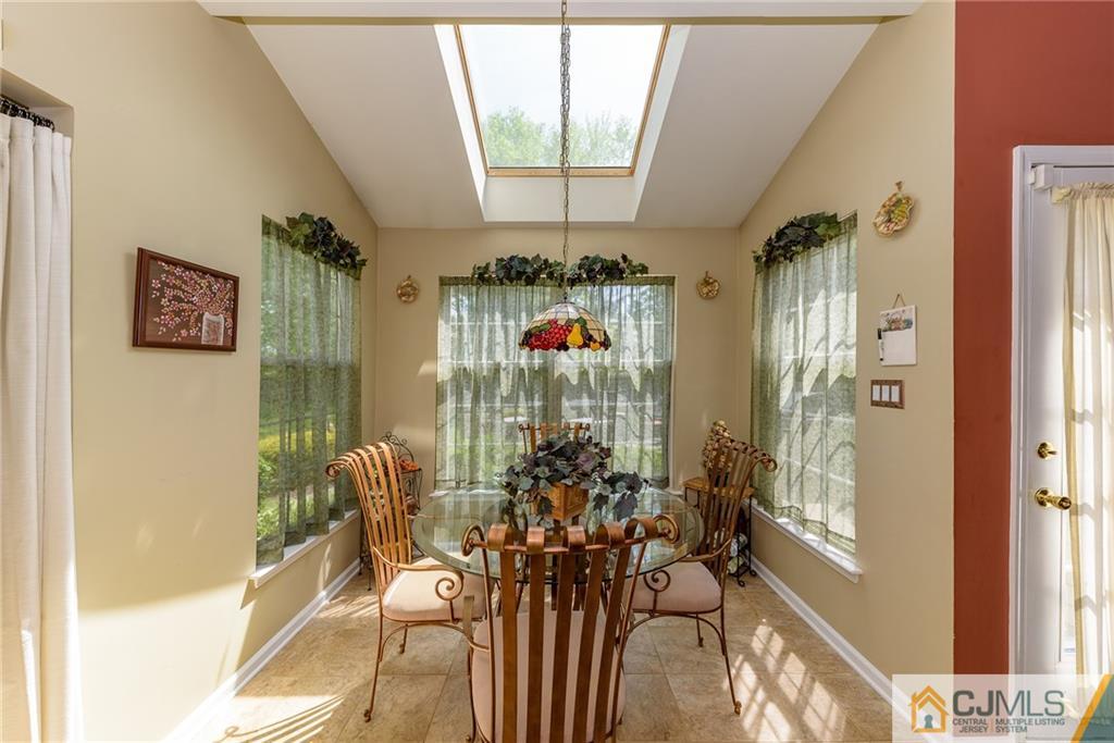 3 Rock Run Road East Windsor, NJ 08520 - Photo 10 of 25 a view of a dining room with furniture wooden floor and a chandelier