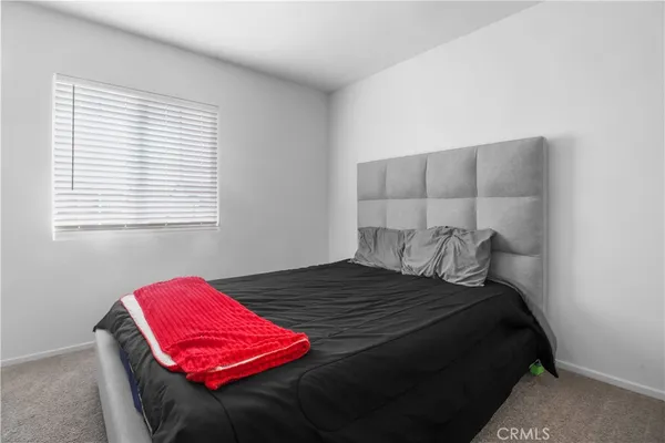 a bedroom with a bed and window