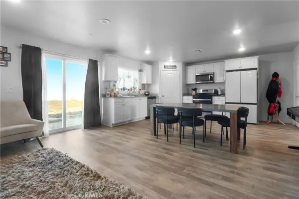 a view of kitchen dining space with furniture and wooden floor
