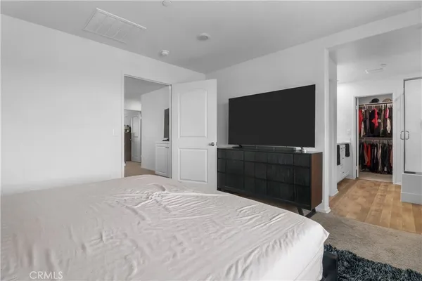 a bedroom with a bed and a flat screen tv