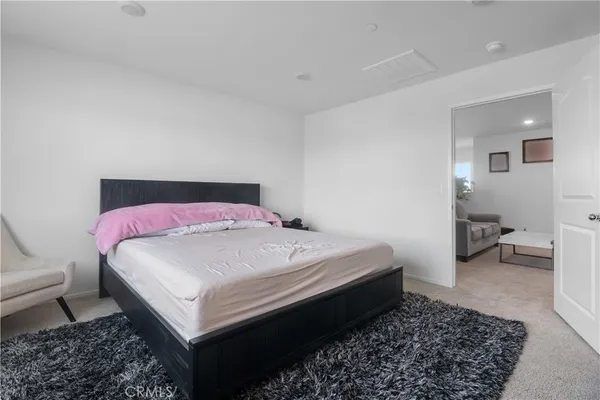 a bedroom with a bed and a couch