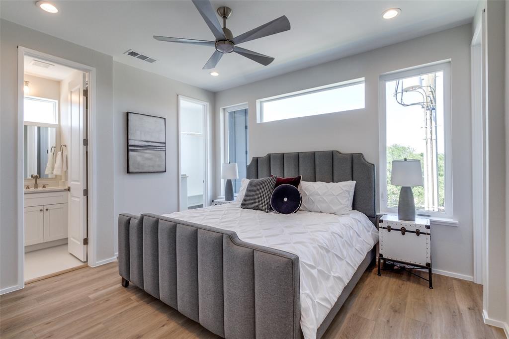 3308 Birmingham Avenue, Unit A1 Dallas, TX 75210 - Photo 25 of 33 a bedroom with a large bed and a chandelier