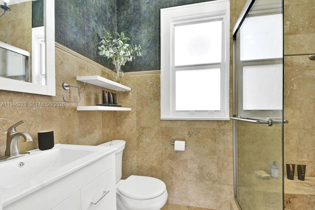 4722 Southwest 5th Street Miami, FL 33134 - Photo 13 of 18 a bathroom with a sink a toilet and shower