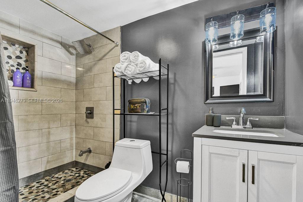 4722 Southwest 5th Street Miami, FL 33134 - Photo 16 of 18 a bathroom with a sink a toilet and shower