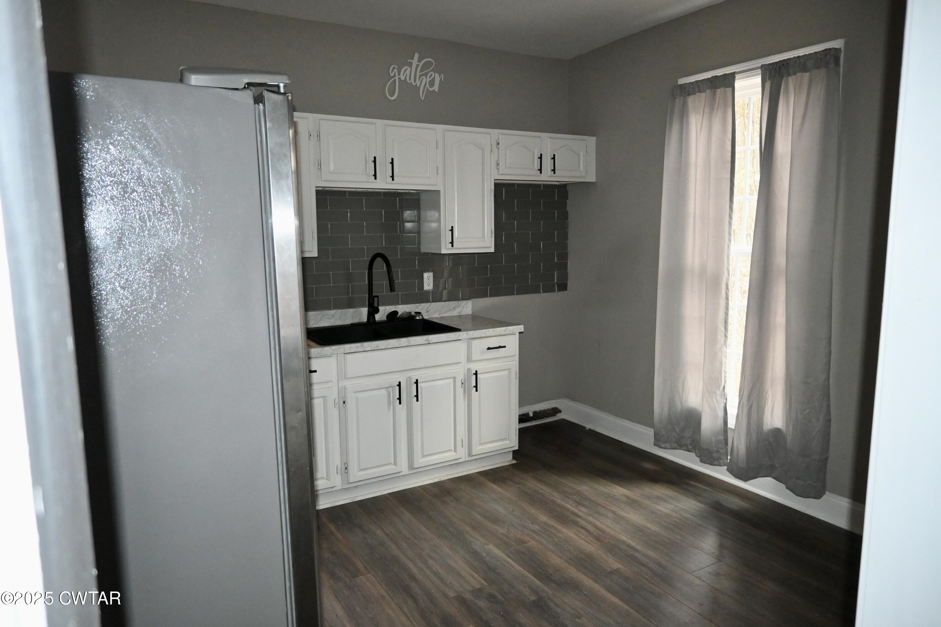 425 North McCombs Street Martin, TN 38237 - Photo 11 of 21 a kitchen with a refrigerator a sink and cabinets