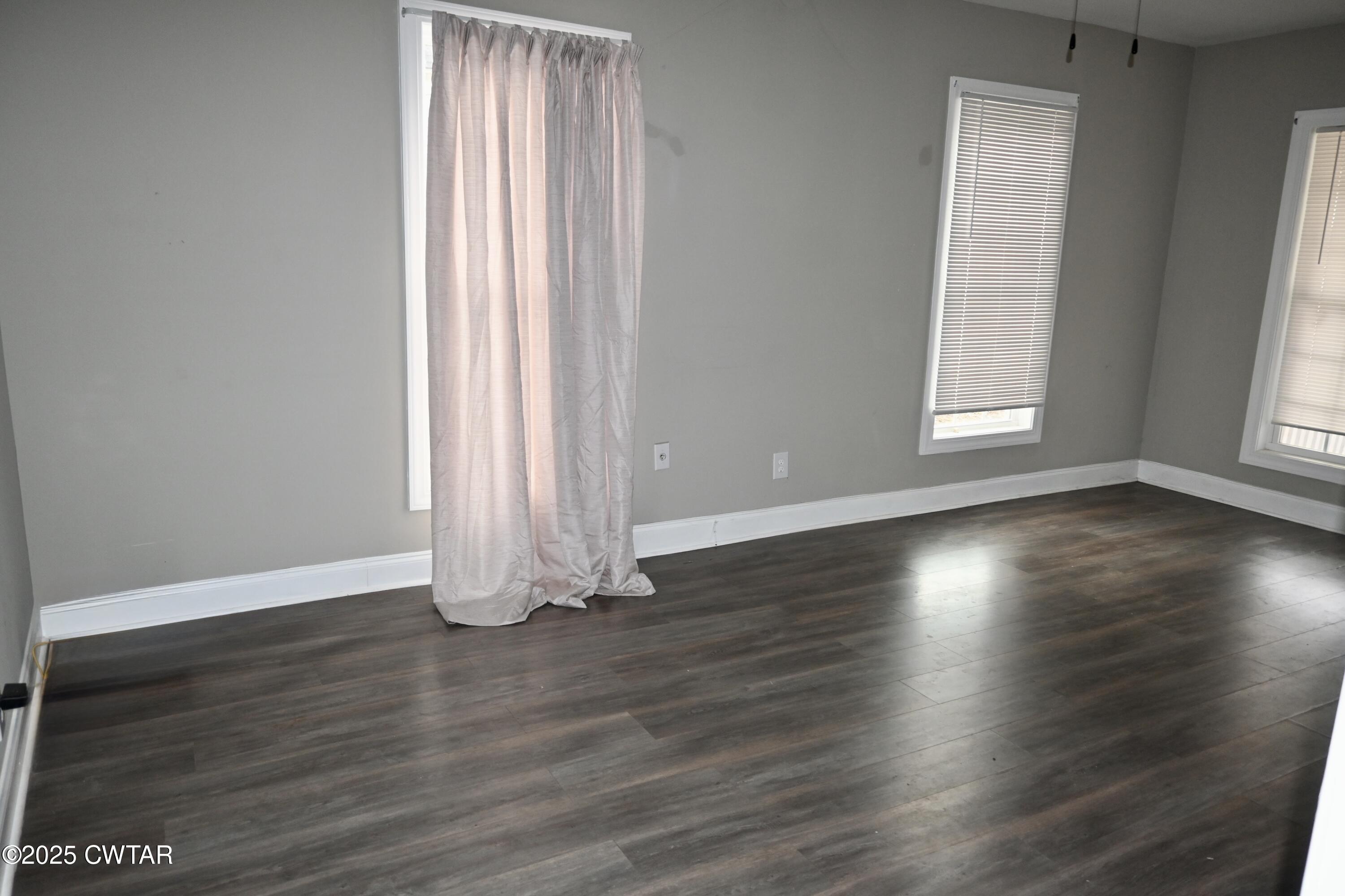 425 North McCombs Street Martin, TN 38237 - Photo 5 of 21 an empty room with wooden floor and windows
