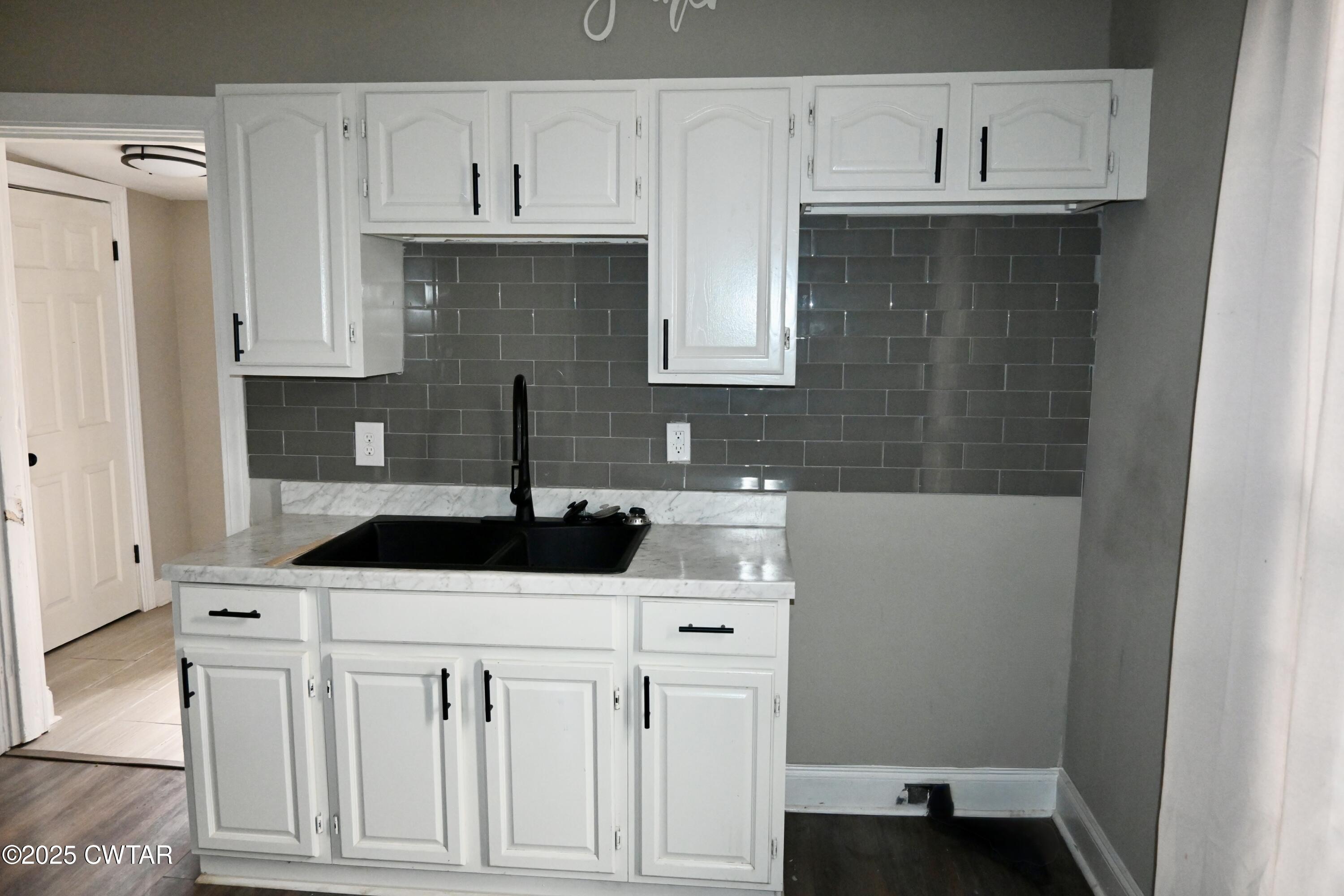 425 North McCombs Street Martin, TN 38237 - Photo 9 of 21 a kitchen with white cabinets and sink