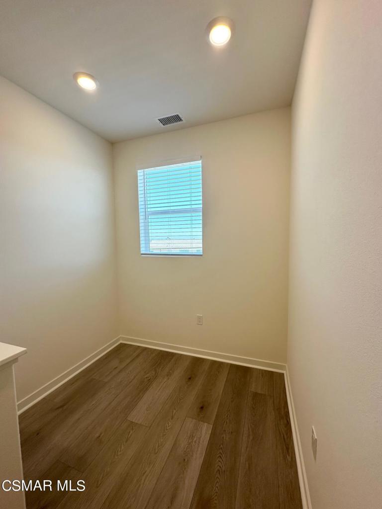 10726 Telegraph Road Ventura, CA 93004 - Photo 11 of 25 an empty room with wooden floor and windows