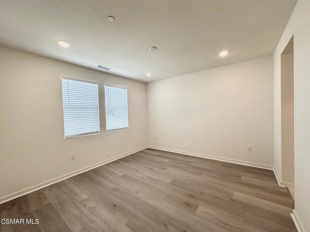 10726 Telegraph Road Ventura, CA 93004 - Photo 7 of 25 a view of an empty room with wooden floor and a window
