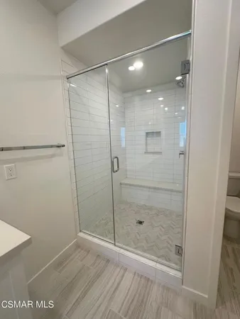 a bathroom with a glass shower door