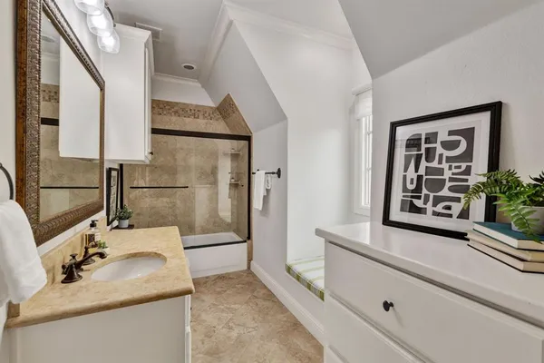 a bedroom with a bed and a chandelier fan