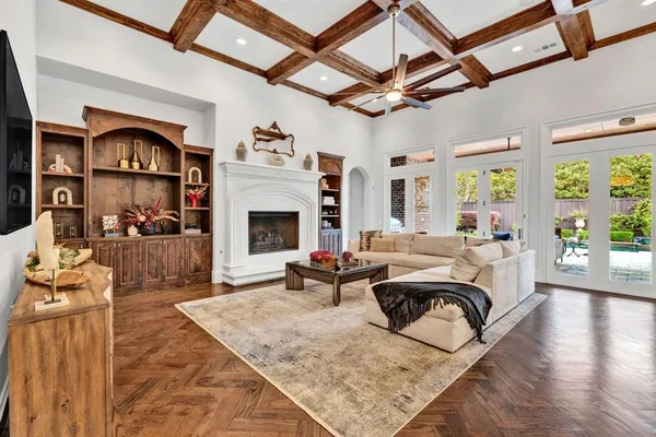 a living room with furniture large window and a fireplace
