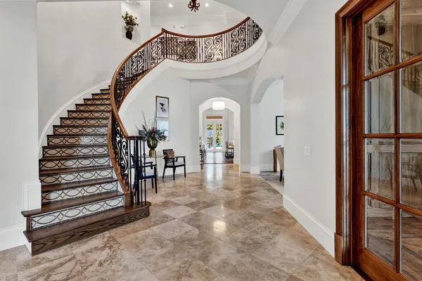 a view of a hallway with entryway wooden floor and front door