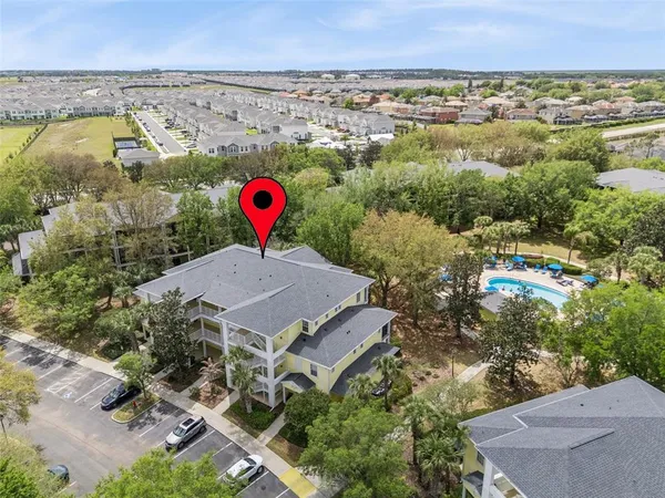 an aerial view of a house with a yard
