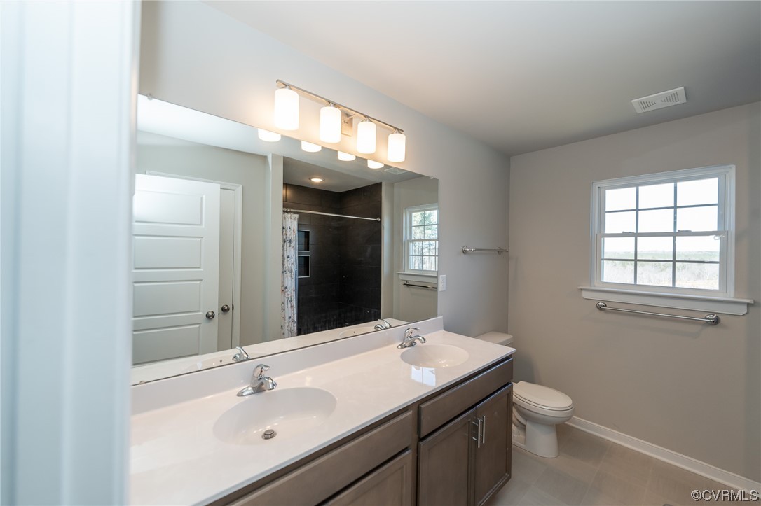 1147 Courthouse Road Palmyra, VA 22963 - Photo 17 of 48 a bathroom with a toilet a sink and mirror